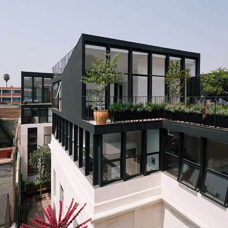 Cadaval & Solà-Morales installs angular black penthouses during renovation of a 1920s building