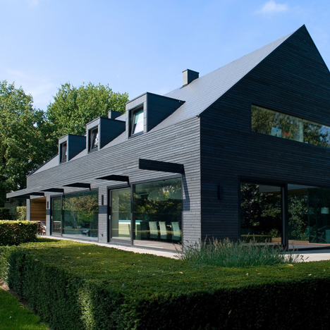 House in the Netherlands upgraded with a dark grey cladding of timber panels and tiles