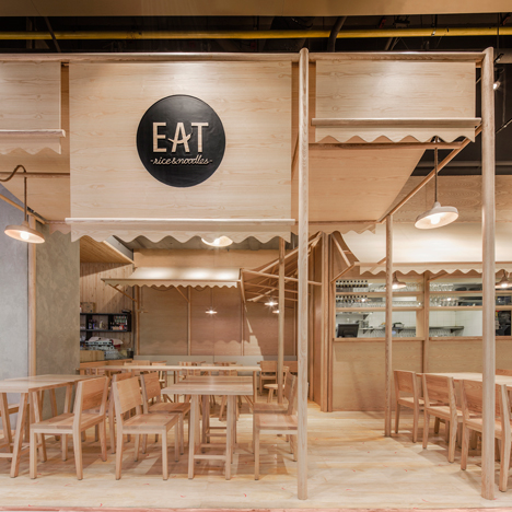 Onion uses solid ash and plywood to create a monochrome restaurant interior in Bangkok
