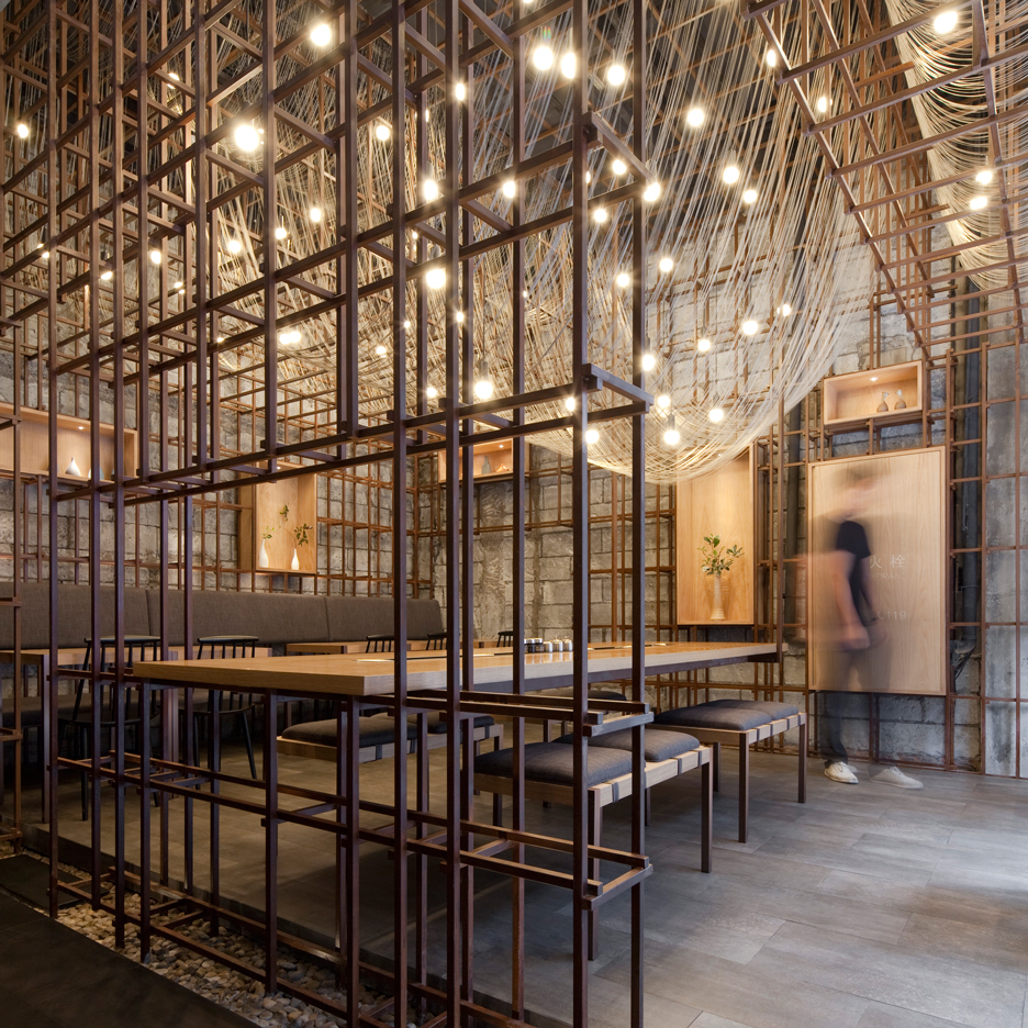 Lukstudio suspends metal wires to look like drying noodles at Chinese restaurant