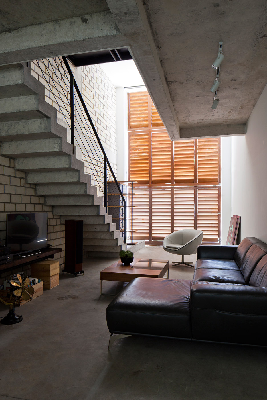Townhouse with a folding-up shutter in Vietnam by MM++ Architects