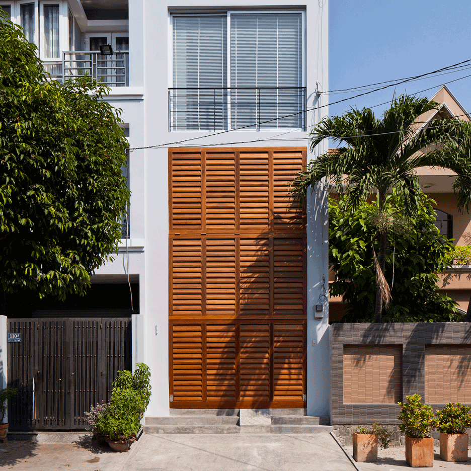 Townhouse with a folding-up shutter in Vietnam by MM++ Architects