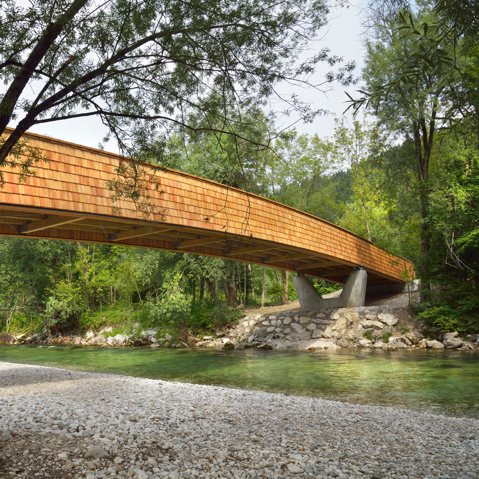 Arching wooden footbridge by DANS Architects connects Slovenian village to mountains