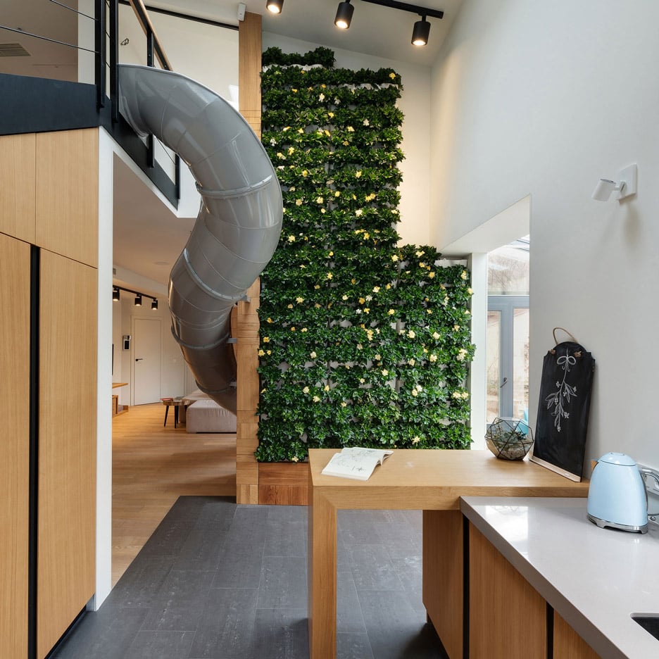 KI Design Studio adds slide and plant-covered wall to Ukraine apartment