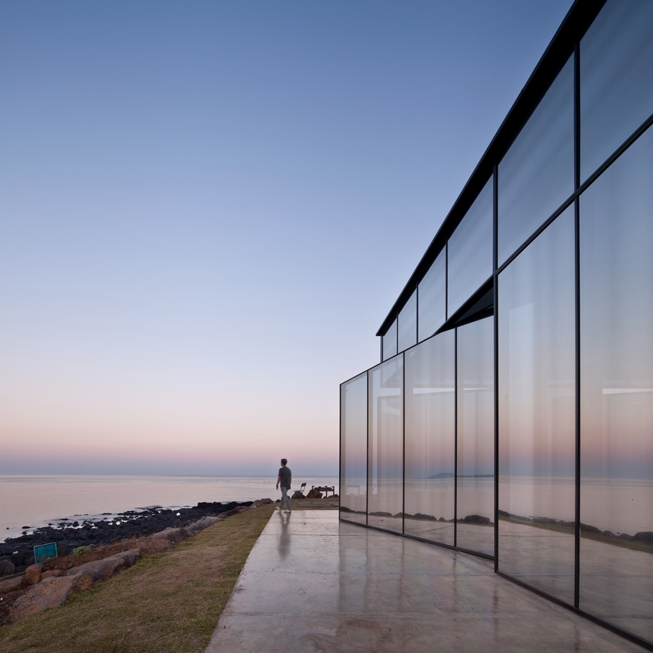 Platform_a completes reflective glass and volcanic stone cafe on Jeju island coast