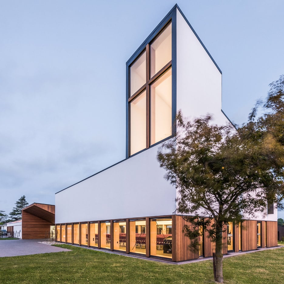 Window with cross-shaped frame forms beacon for rebuilt church by Dalman Architecture