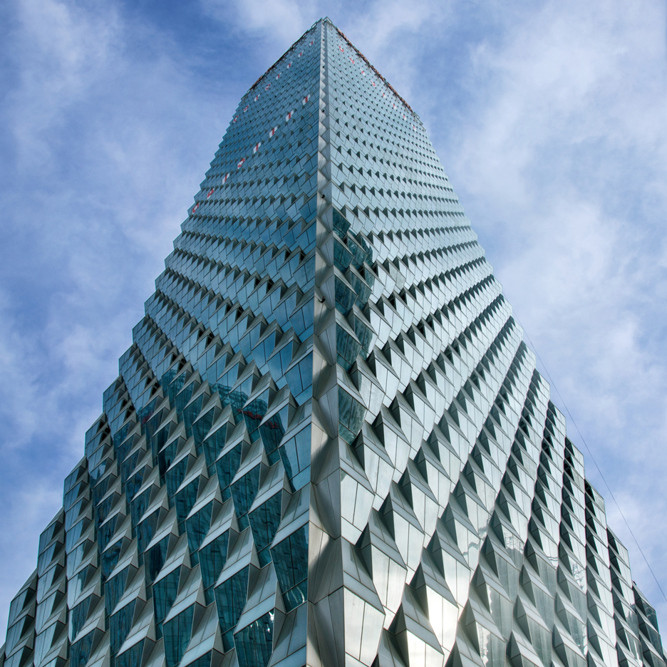 Trapezoidal glass panels create prismatic facades for SOM's Beijing skyscraper