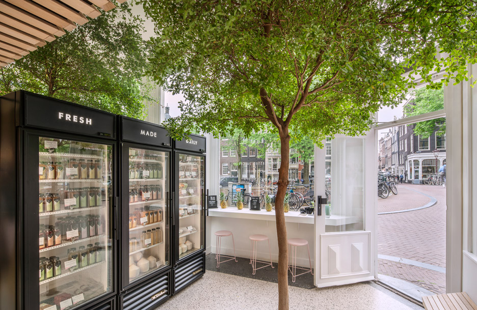 The Cold Pressed Juicery in Amsterdam designed by Standard Studio houses a living tree