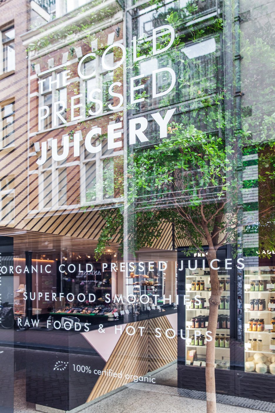 The Cold Pressed Juicery in Amsterdam designed by Standard Studio houses a living tree