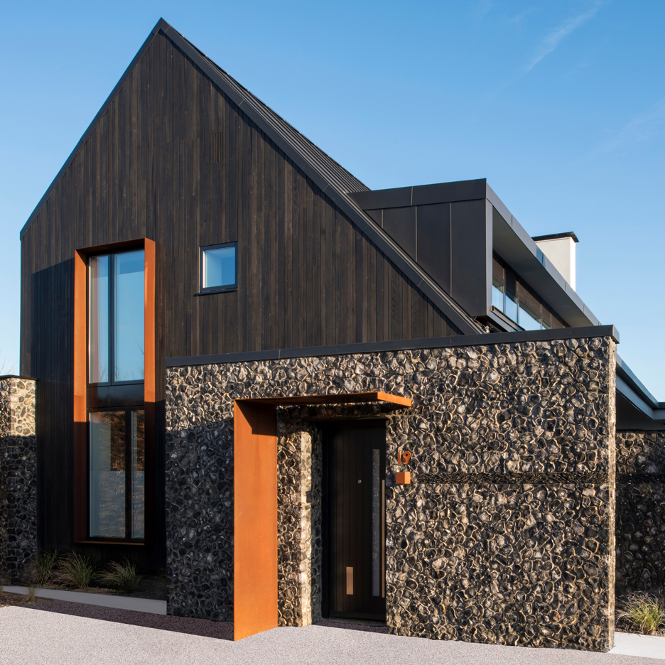 Rugged flint walls contrast dark cedar gables of House 19 by Jestico + Whiles