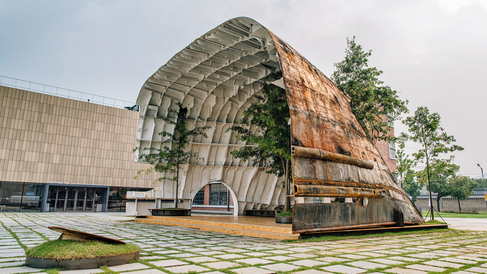Rusty ship transformed into cavernous pavilion in Seoul