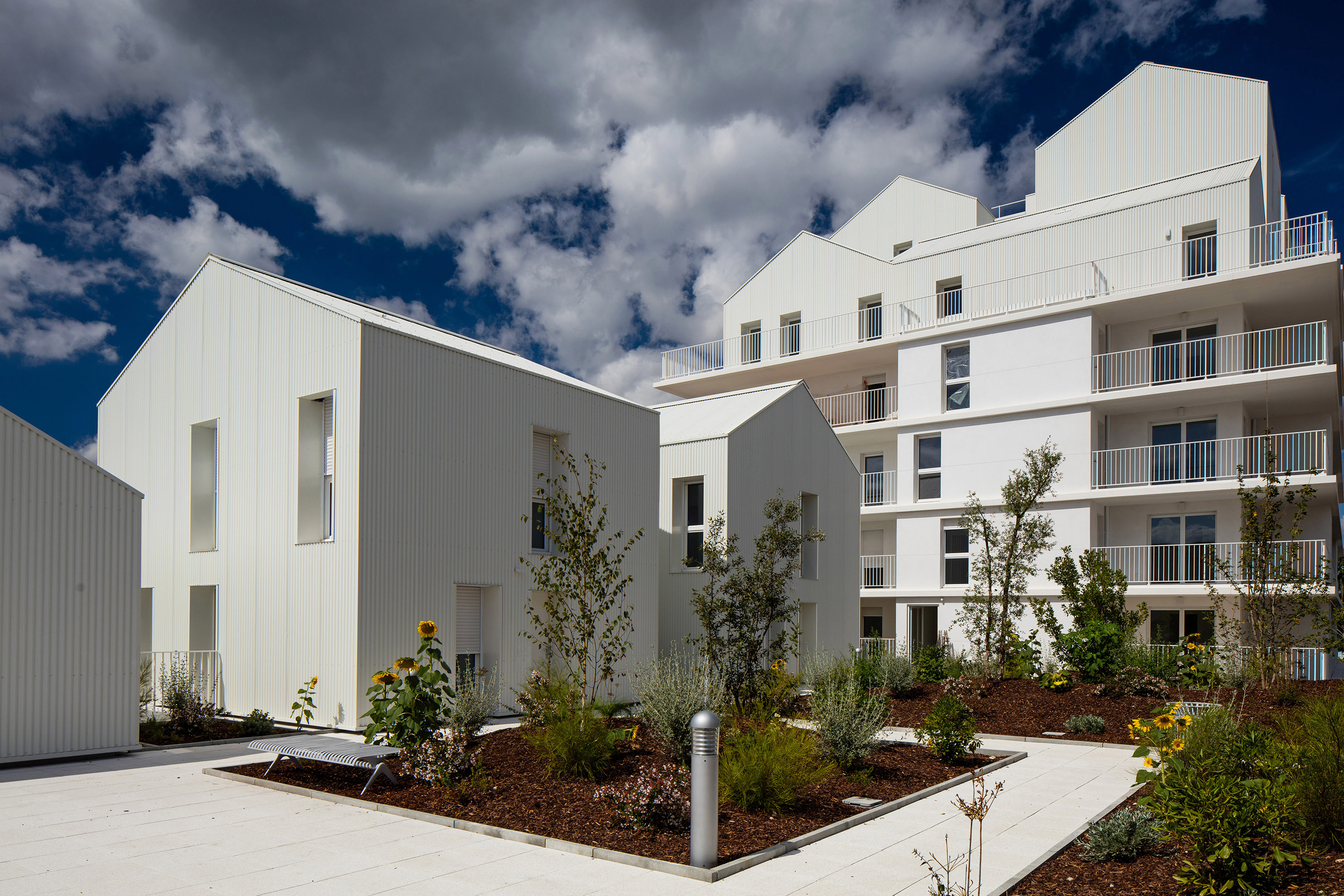 Gabled penthouses sit atop apartment blocks at Bordeaux housing scheme