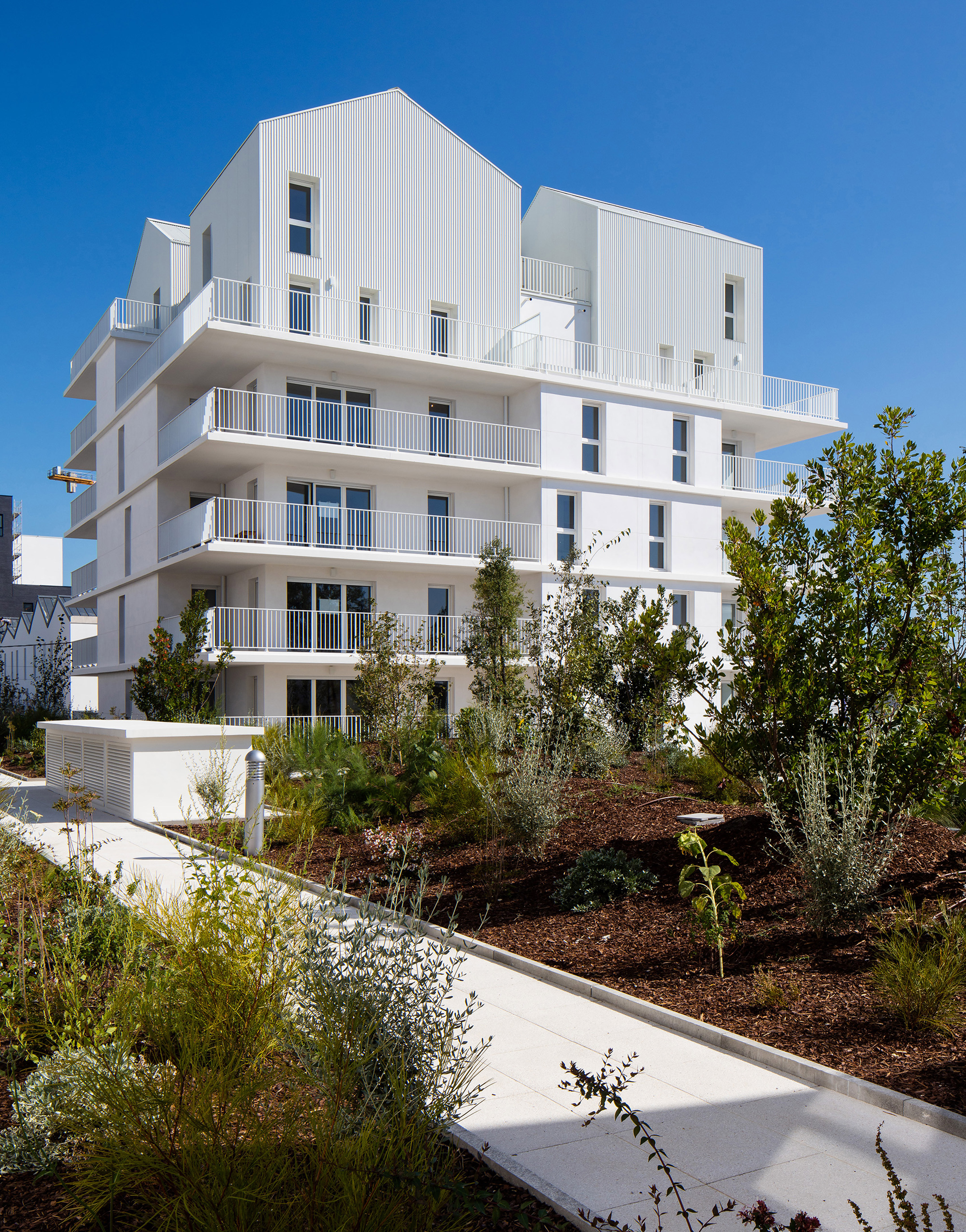 Gabled penthouses sit atop apartment blocks at Bordeaux housing scheme