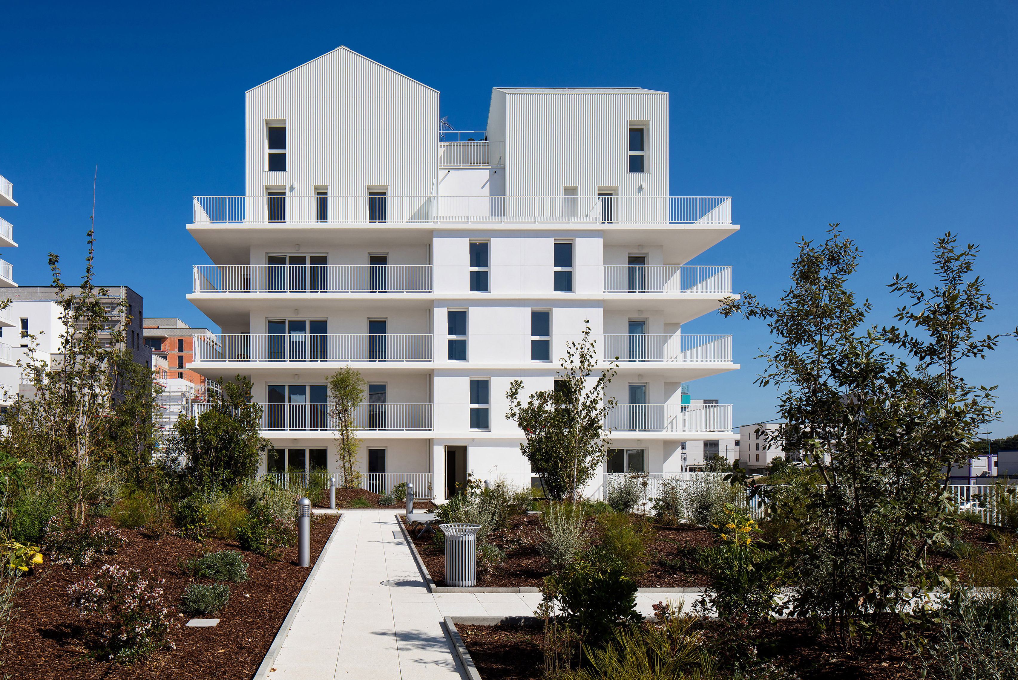 Gabled penthouses sit atop apartment blocks at Bordeaux housing scheme