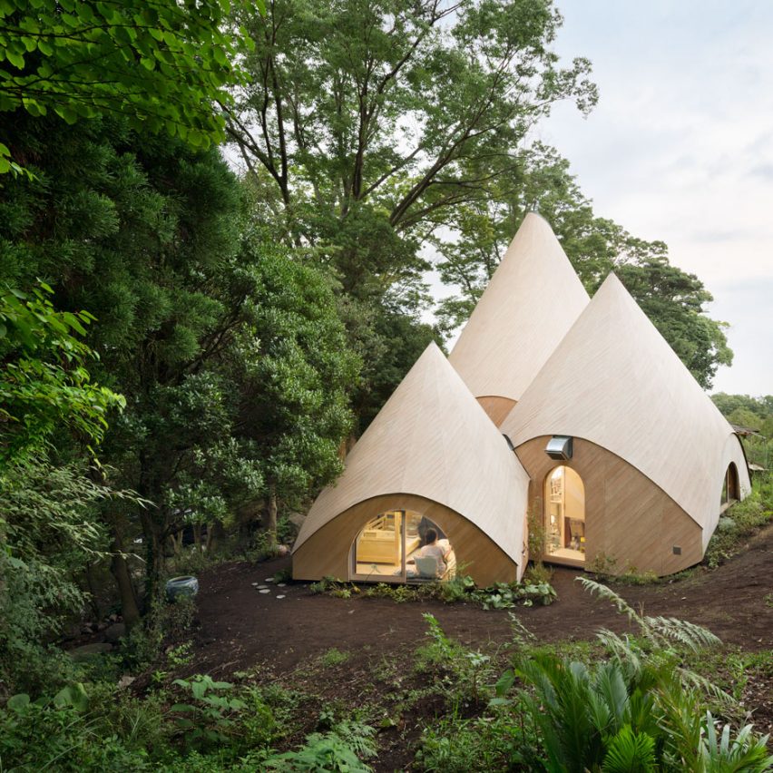 Teepee-shaped buildings by Issei Suma house community kitchen and spiral-shaped pool