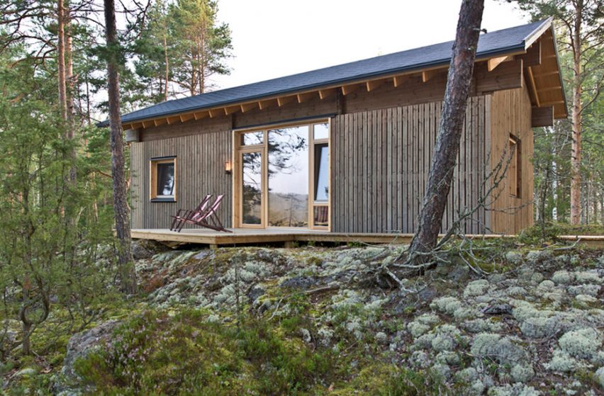 Lake cabin by Sini Kamppari features slatted timber siding and projecting terrace
