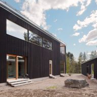 House H by Teemu Hirvilammi features a black exterior and pale wood interior