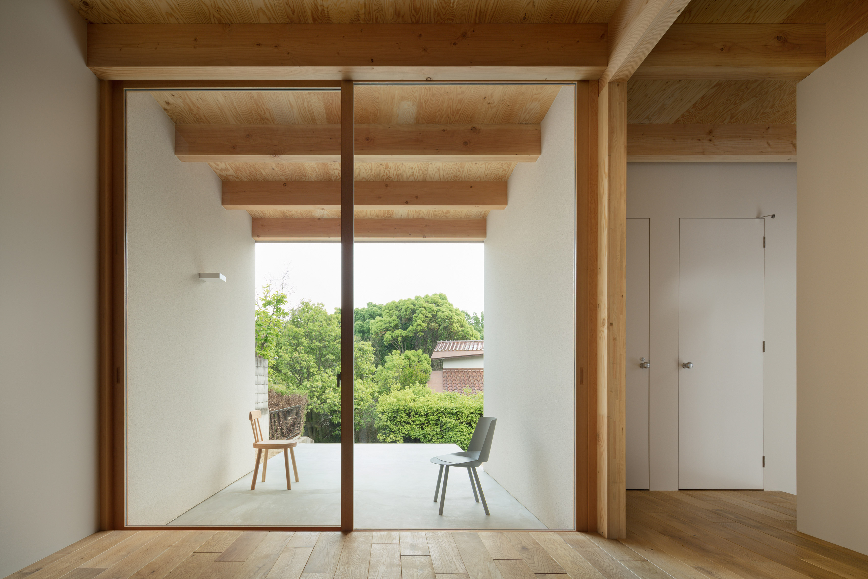 House in Mikage by Sides Core contrasts white surfaces with exposed wooden beams