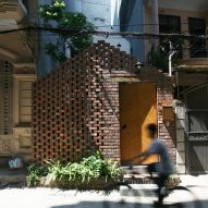 Perforated brick gable screens courtyard in front of compact Hanoi house