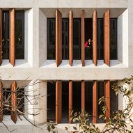 Tehran office building features facade divided into a grid of faceted window frames