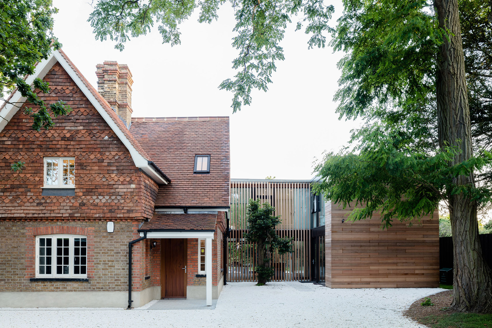 McGarry-Moon Architects adds concrete, timber and glass extension to a traditional gatehouse