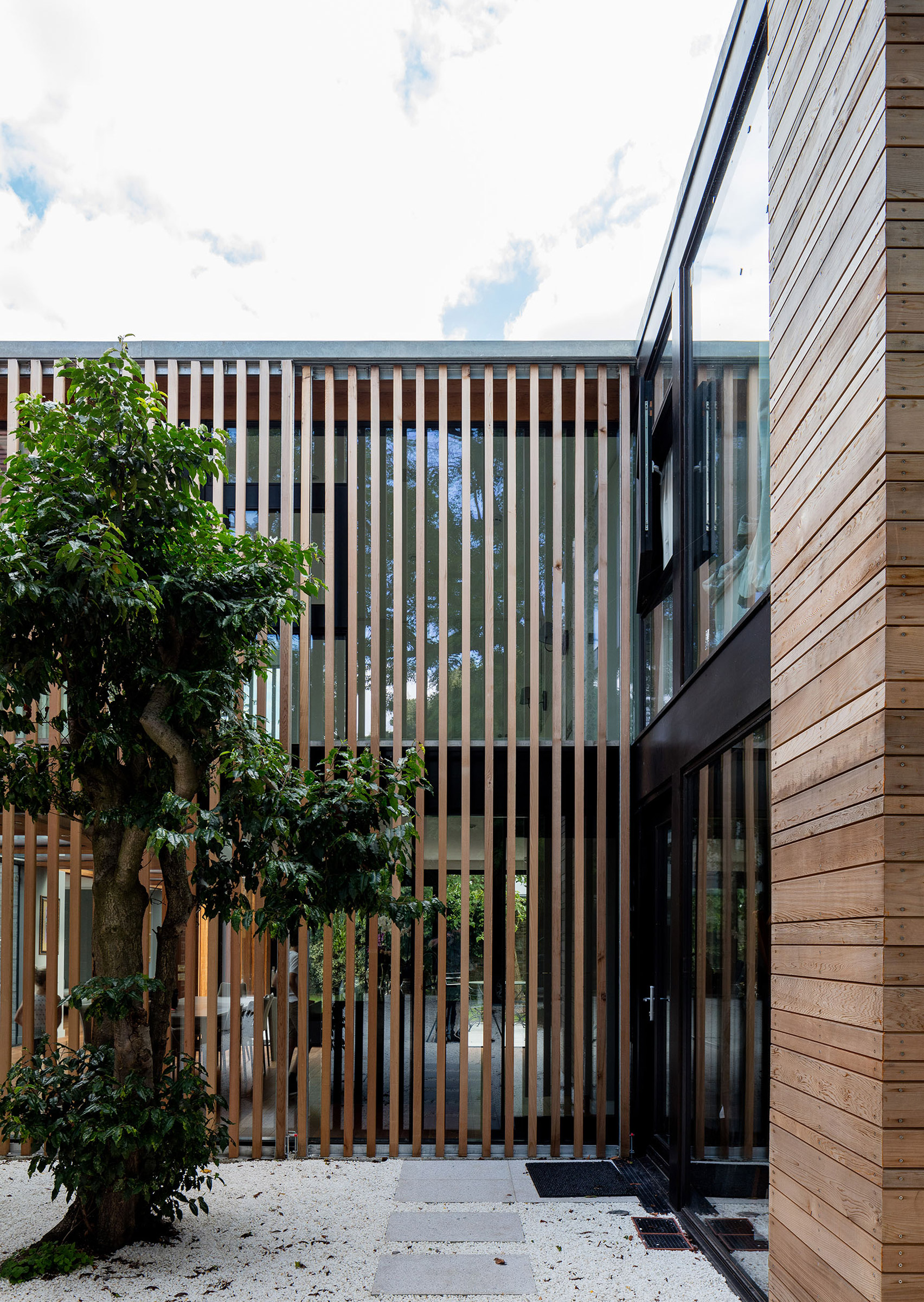 McGarry-Moon Architects adds concrete, timber and glass extension to a traditional gatehouse