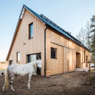 Wooden stables completed by Pook on the edge of a Finnish forest
