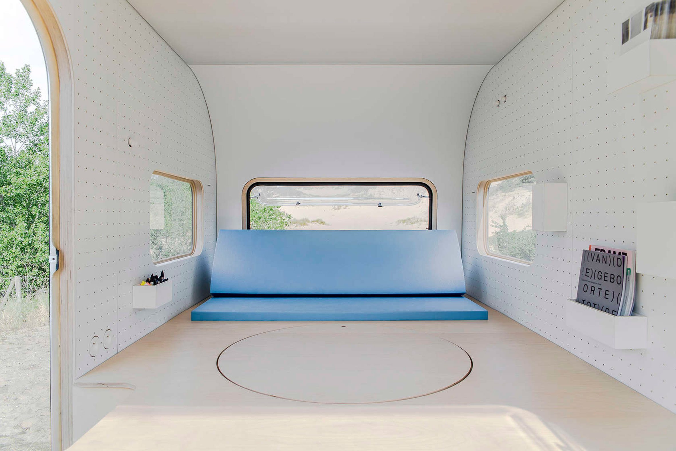 Five AM turns caravan into studio with pop-up table and pegboard walls