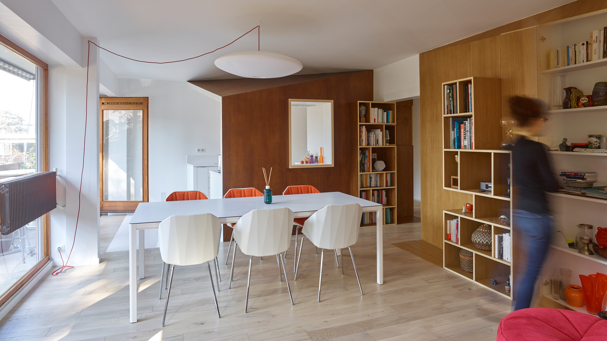 Clutter concealed within wooden walls inside French apartment