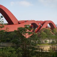 Wavy red ribbons form Lucky Knot bridge by NEXT Architects