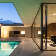 Frameless glazing and concrete canopy shelter pool-side lounge by Steven Vandenborre