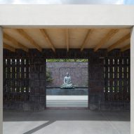 Colonnades frame landscaped courtyards at Buddhist retreat in rural England