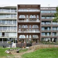 Arches puncture brick facade of Amsterdam apartment block by WE Architecten