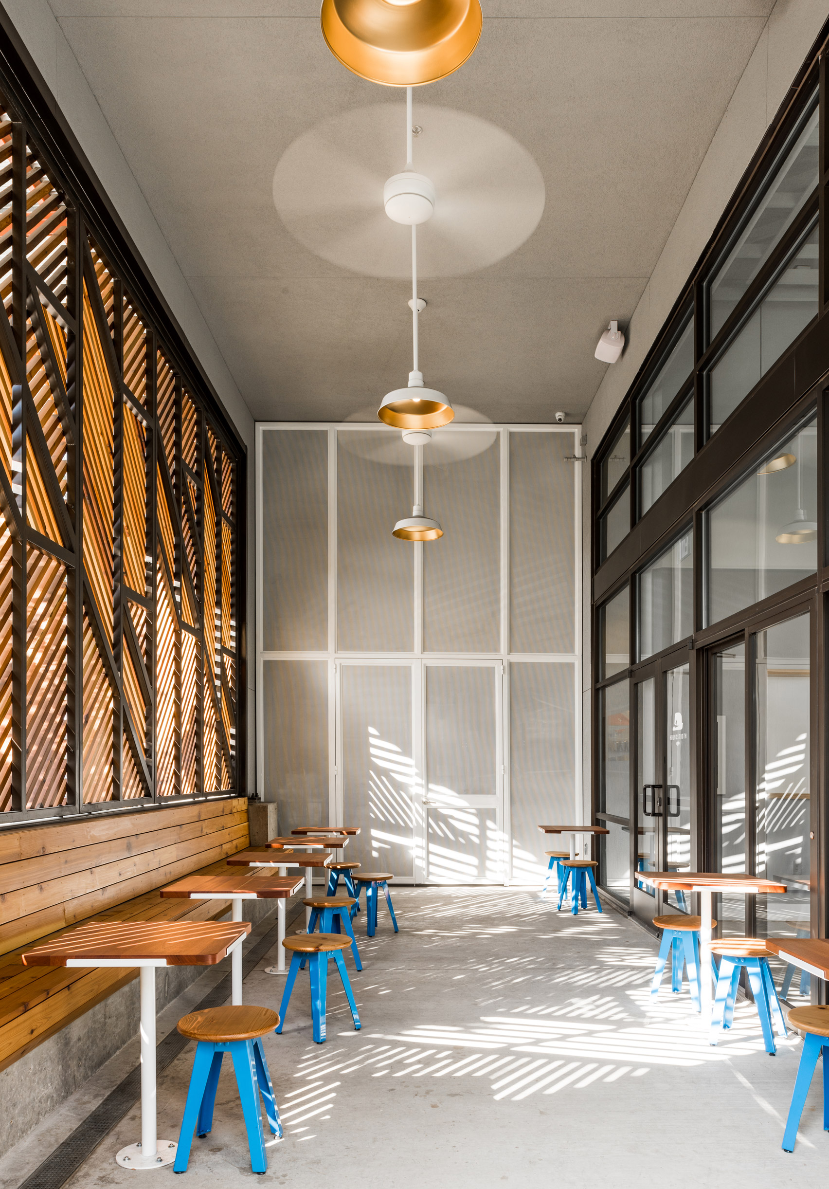 Official designs light-filled cafe and dark cocktail bar in Dallas