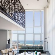 Pitsou Kedem designs dark brass lattice wall for Tel Aviv apartment