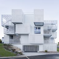 White irregularly stacked boxes form social housing in France by Poggi + More
