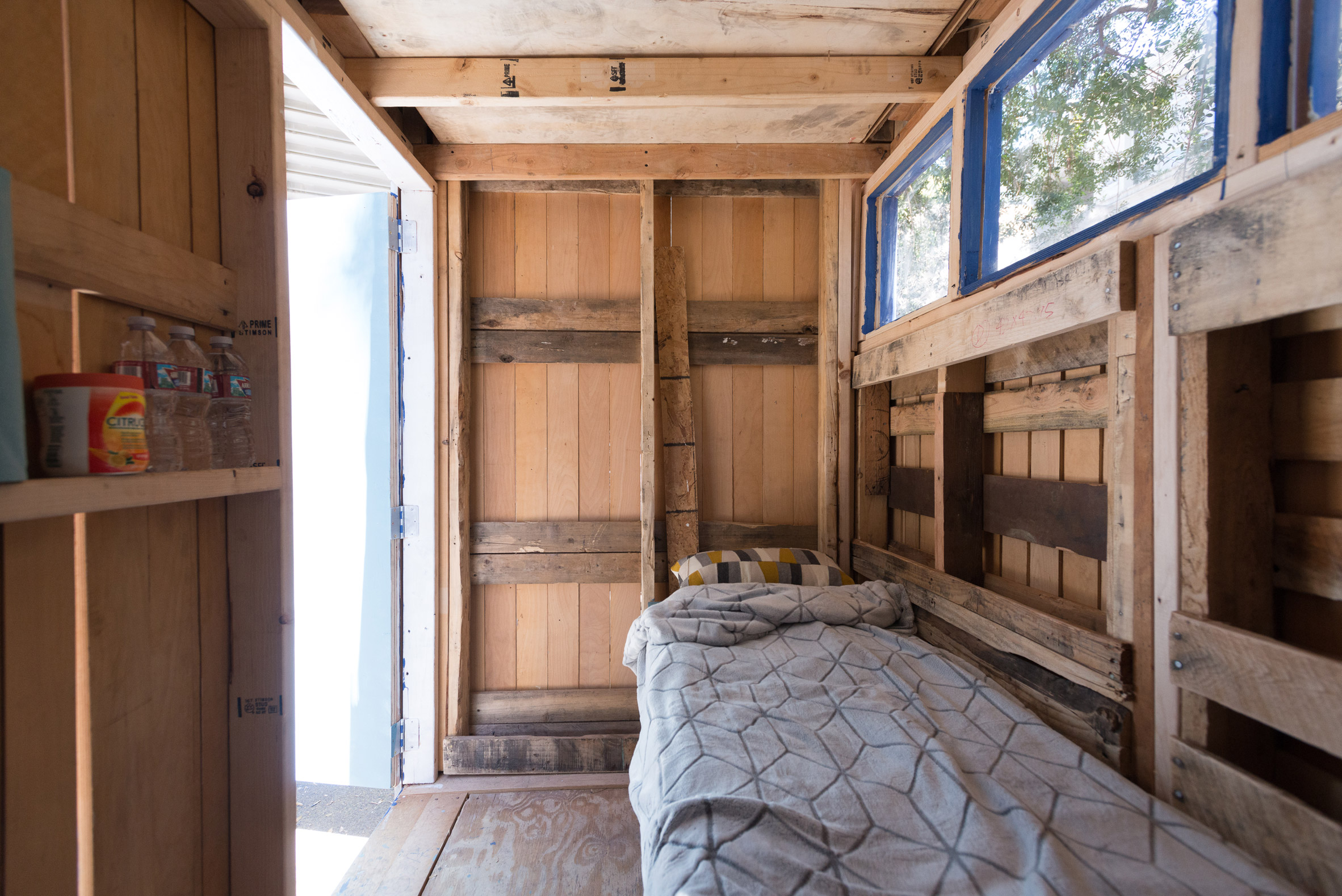 Tiny Home - interior with bed, shelves and windows