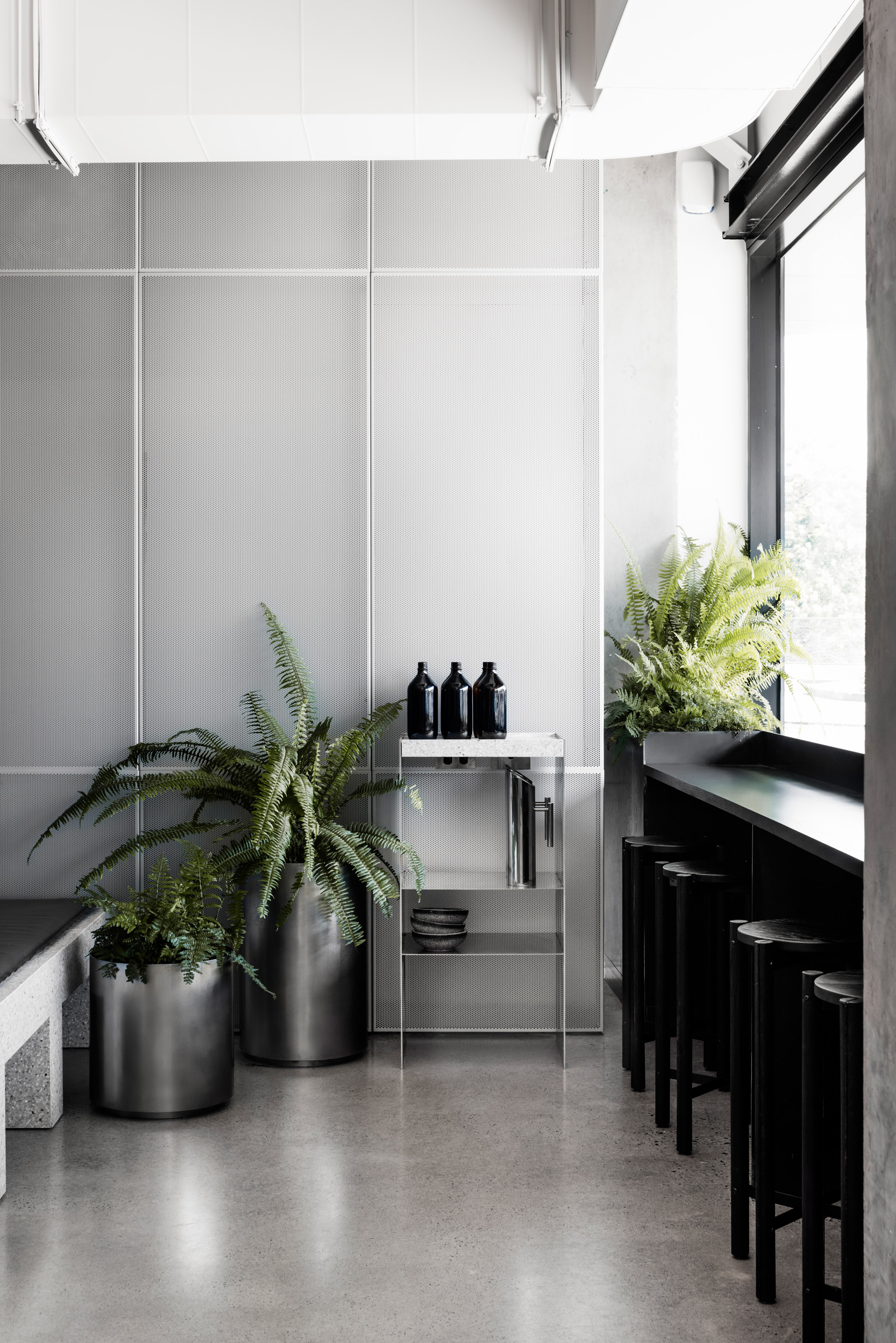 Concrete and terrazzo furniture feature in Ritz&Ghougassian's minimal cafe interior