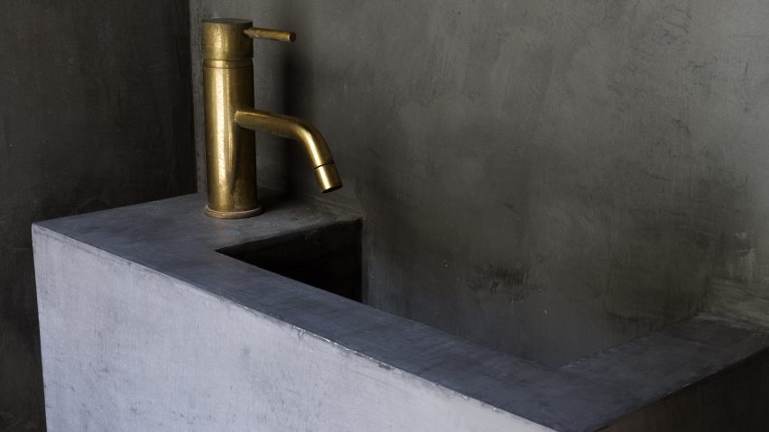Concrete sink with metal tap