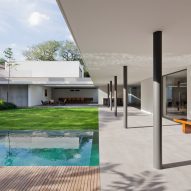 Plant-filled courtyards create natural enclaves in Brazilian home by AMZ Arquitetos