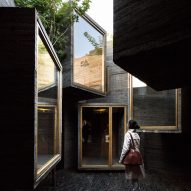 Micro hostel with tiny concrete rooms installed by Zhang Ke in old Beijing hutong