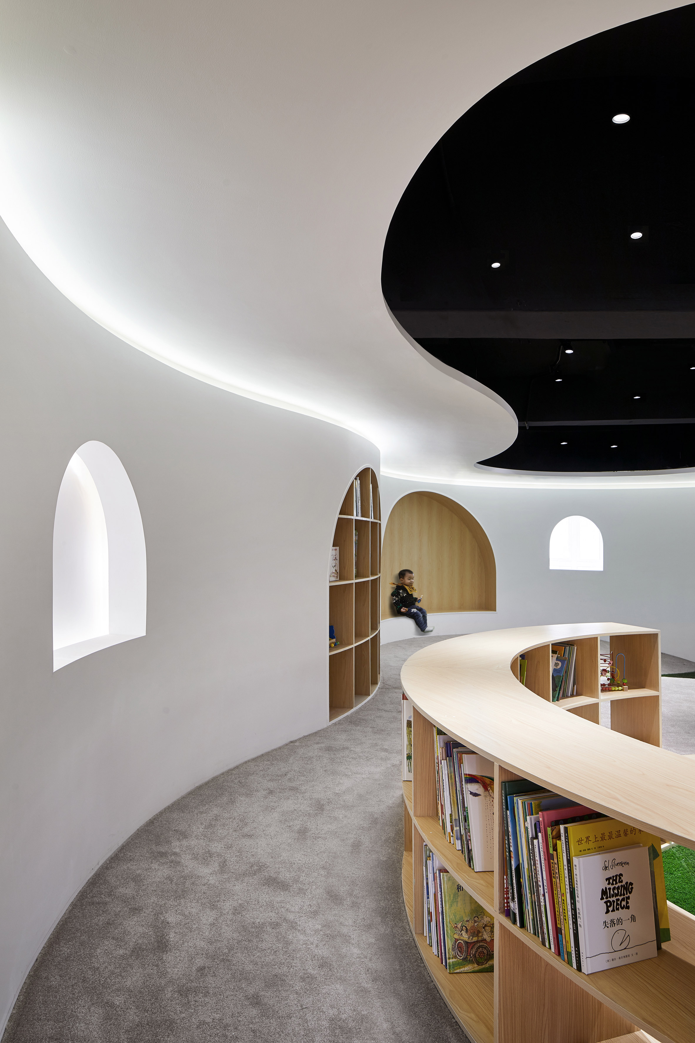 Curving wood-lined nooks create private reading spaces in Shanghai children's library