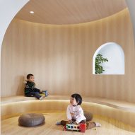 Curving wood-lined nooks create private reading spaces in Shanghai children's library