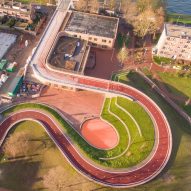 Red cycle path by NEXT and Rudy Uytenhaak snakes over Utrecht school and canal