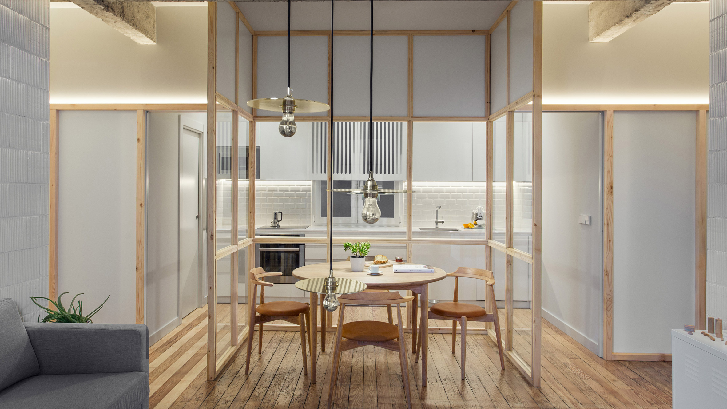 A kitchen with a glass partition