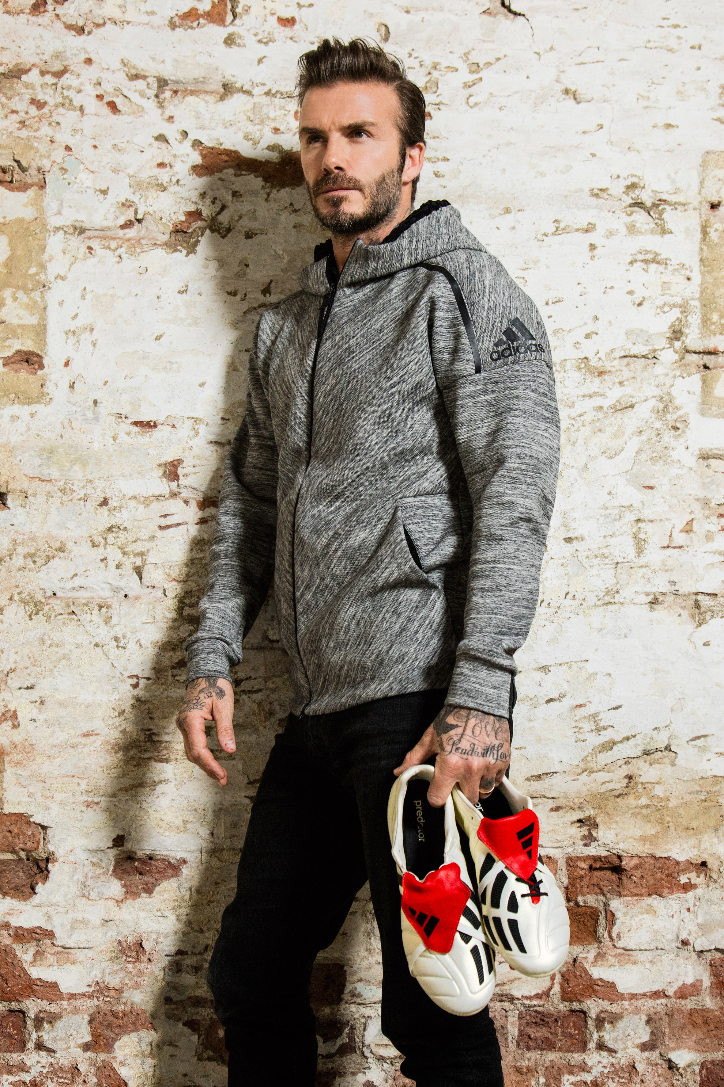 Former Manchester United and Real Madrid midfield David Beckham holding the new Predator Mania boots.