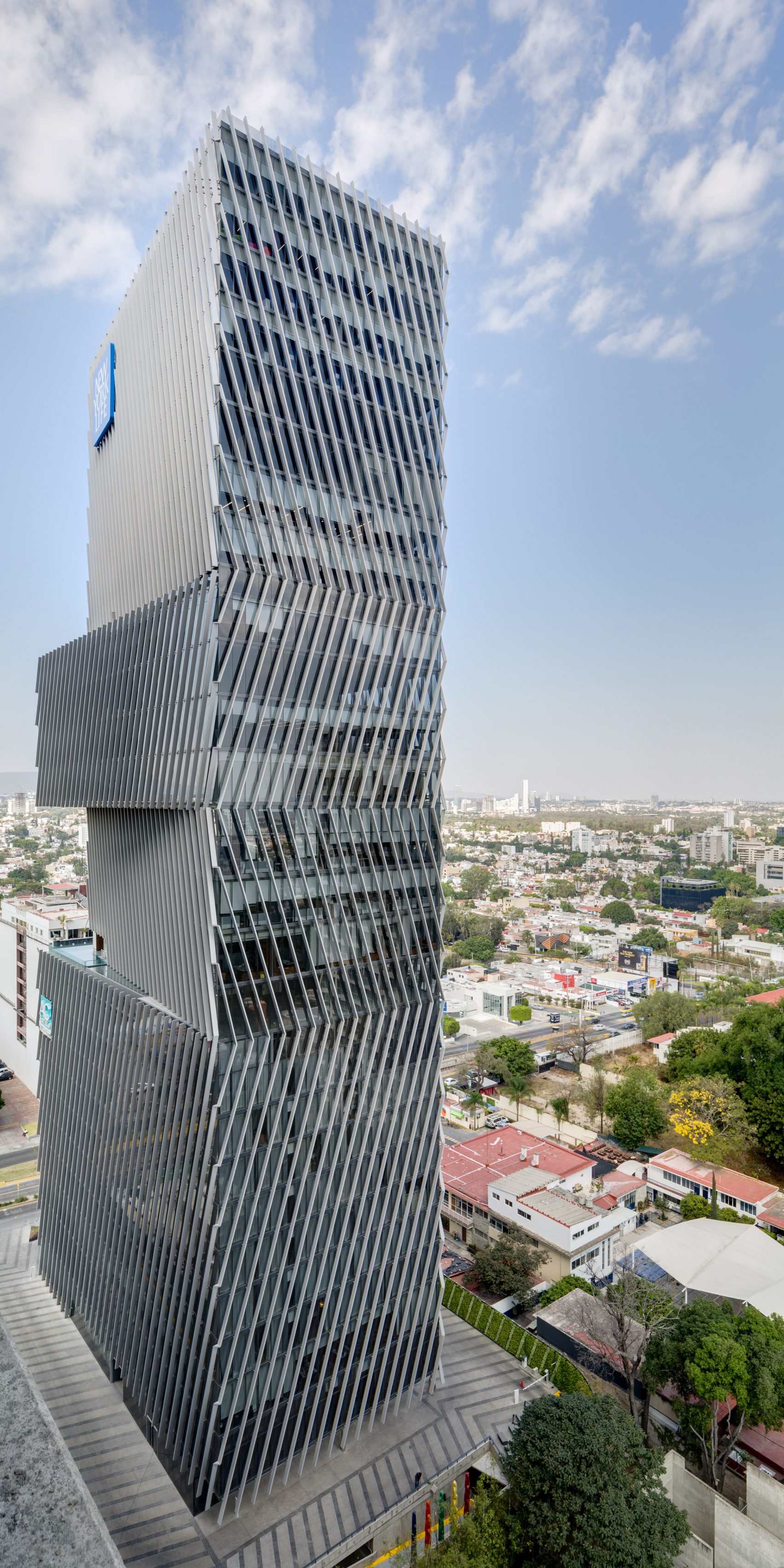 Angled louvres shade glass skyscraper in Guadalajara by Sordo Madaleno  Arquitectos