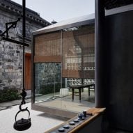 Glazed meditation room overlooks traditional courtyard from Nanjing home