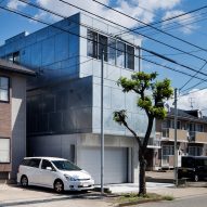 Galvanised steel panels cover irregularly stacked volumes of Japanese townhouse