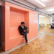 Interrobang fills its office with custom plywood furniture painted the colours of insulating foam